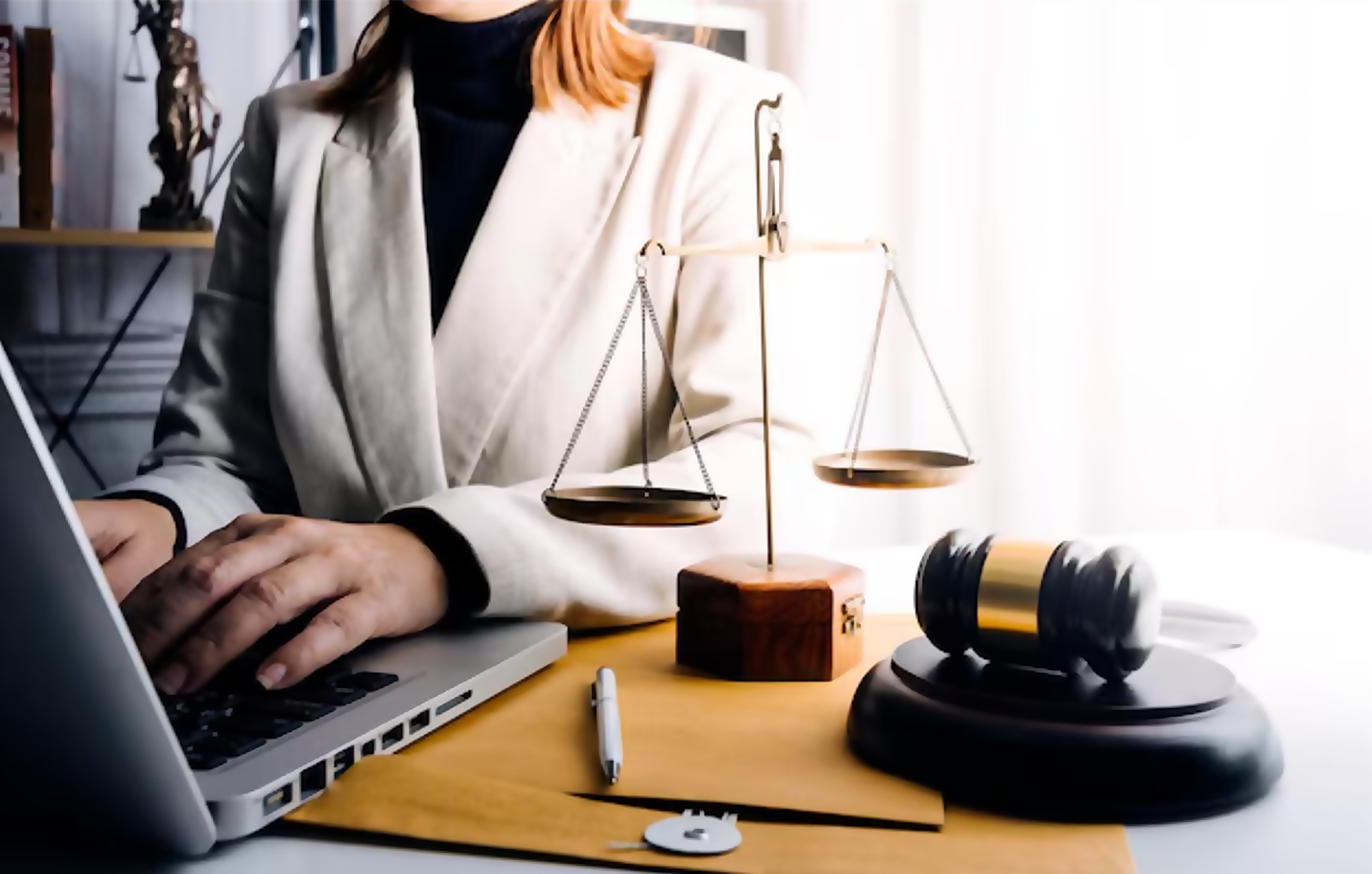 Lawyer working on a laptop with legal scales and gavel, symbolizing DUI legal rights and employment implications.